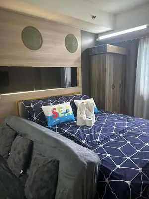 a bedroom with a bed with two stuffed animals on it at AJ Staycation in Manila