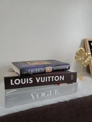 three books stacked on top of each other on a table at 1 Bedroom Apartment with Mountain View and WiFi in Manila