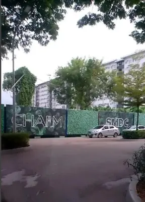 a car parked in a parking lot next to a fence at 1 Bedroom Apartment with Mountain View and WiFi in Manila