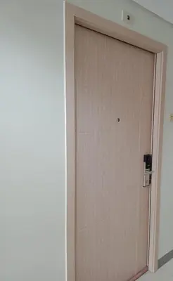 a wooden door in a room next to a wall at 1 Bedroom Apartment with Mountain View and WiFi in Manila