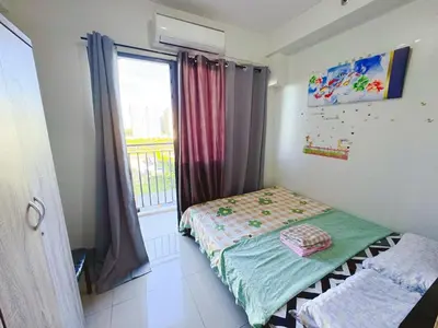 a small bedroom with a bed and a window at City View Shore2 Residence Tower1 in Manila