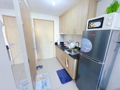 a small kitchen with a refrigerator and a sink at City View Shore2 Residence Tower1 in Manila
