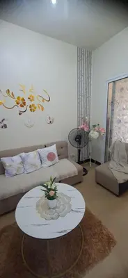 a living room with a couch and a table at Villa Felize Homestay at Torre de Manila in Manila