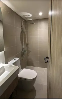 a bathroom with a toilet and a sink and a shower at Luxury 2BR Condo in Makati Near Malls & Offices in Manila