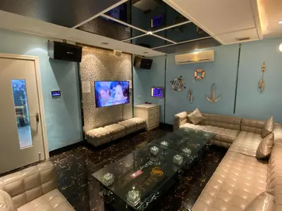 a living room with a couch and a tv at Sun Star Grand Hotel in Manila