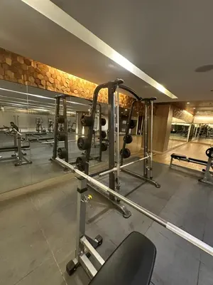 a gym with several tread machines in a room at Mall of Asia residence shore 3 in Manila