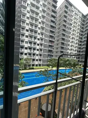 a balcony with a view of a pool and buildings at Mall of Asia residence shore 3 in Manila