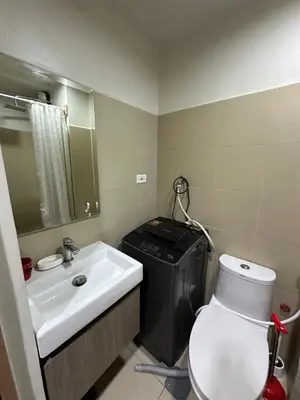 a bathroom with a white toilet and a sink at Mall of Asia residence shore 3 in Manila