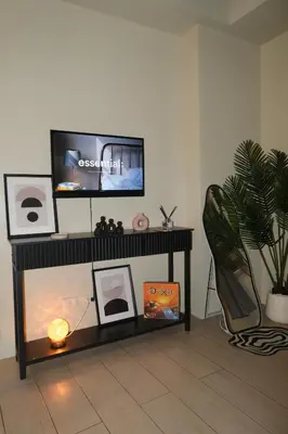 a living room with a tv on a table at Cluster 3, 81 Newport Blvd near NAIA T3 in Manila