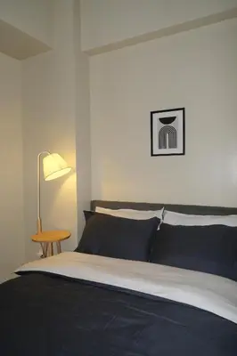 a bedroom with a black and white bed and a table at Cluster 3, 81 Newport Blvd near NAIA T3 in Manila