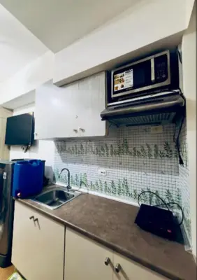 a kitchen with a sink and a microwave at Room for Rent in Manila