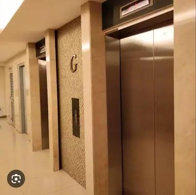 a elevator in a building with a clock on the wall at Room for Rent in Manila