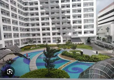 a large apartment building with a large swimming pool at Room for Rent in Manila