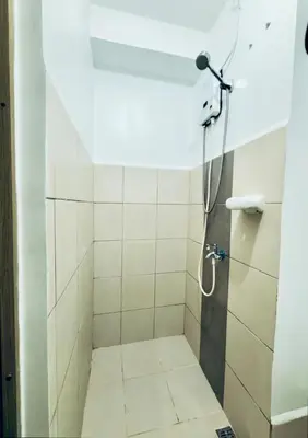 a bathroom with a shower with a shower head at Room for Rent in Manila