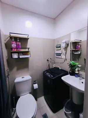 a bathroom with a toilet and a sink at The Ohana Nook in Manila