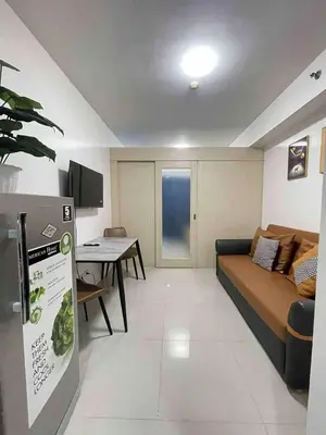 a living room with a couch and a table at Sea residences Sweetest escape in Manila
