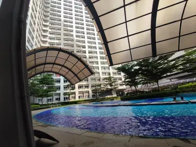 a large swimming pool in front of a large building at SMDC Grace Residences Tower 4 in Manila