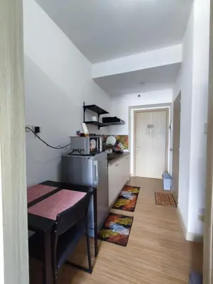 a small kitchen with a table and a microwave at SMDC Grace Residences Tower 4 in Manila