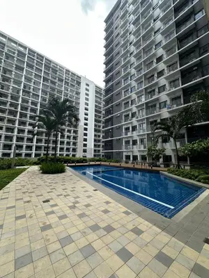a swimming pool in front of two tall buildings at Gateway Mall of asia Shore 3 in Manila