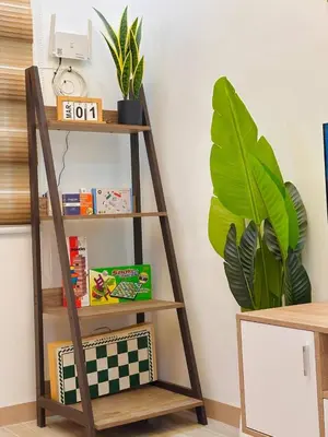 a wooden shelf with a plant in a room at PPL Homestay