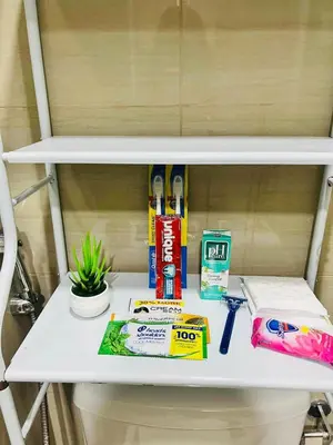 a shelf with toothbrushes and other items on it at The Sunset Cozy Suite at Shore 1 in Manila