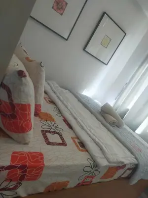 a bed with a blanket on top of it at Sea Residence Condotel Tower E&F in Manila