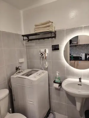 a bathroom with a sink and a toilet and a mirror at Ana's Homestay at Sea Residences in Manila