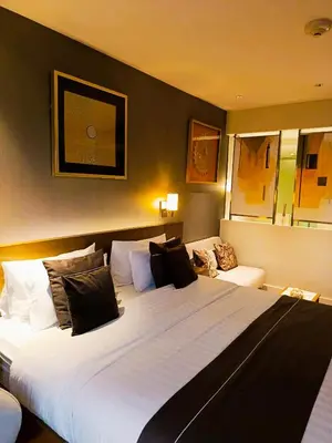 a bedroom with a large white bed in a room at DE LUX SUITE at Novotel Manila Hotel Residences Acqua in Manila