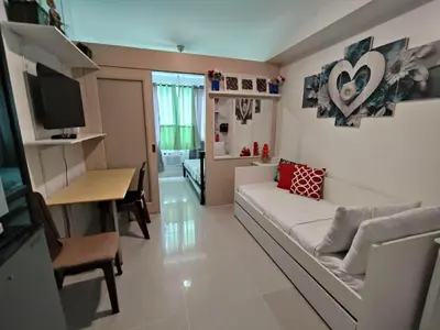 a living room with a couch and a table at Lornas Place in Manila