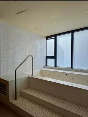 a bathroom with a bath tub with a window at Cozy Studio Unit at The Knightsbridge Residences in Manila