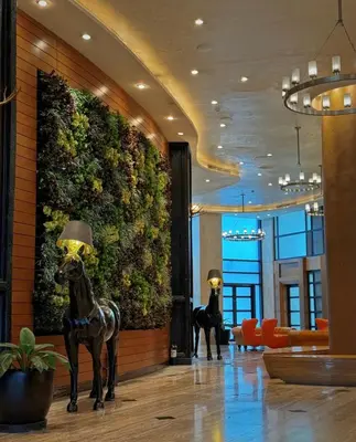 a lobby with two statues of horses in a building at Cozy Studio Unit at The Knightsbridge Residences in Manila