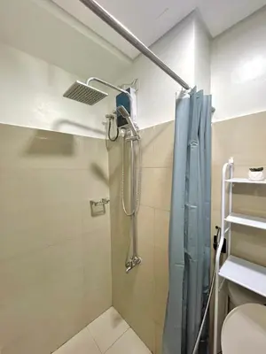 a bathroom with a shower with a glass door at E&C Rentals in Manila