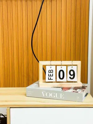 a desk with a clock on top of a book at Azure 1BR Near NAIA 20 mins Wave Pool in Manila