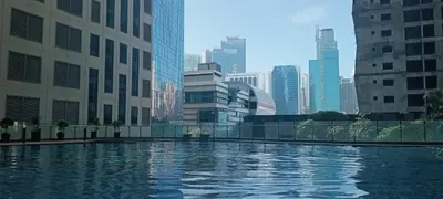 a large pool of water in a city with tall buildings at Modern Cozy Studio in Makati City with Free Pool, Sauna and Gym in Manila