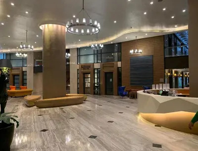 a lobby of a building with tables and chairs at 61F City View at Knightsbridge Makati in Manila