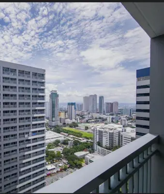 a view of a city from the balcony of a building at Garcia's Unit02, SMDC Fame Residences in Manila