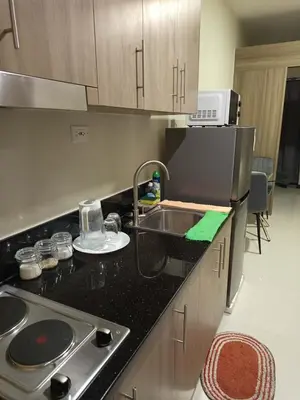 a kitchen with a sink and a counter top at Garcia's Unit02, SMDC Fame Residences in Manila