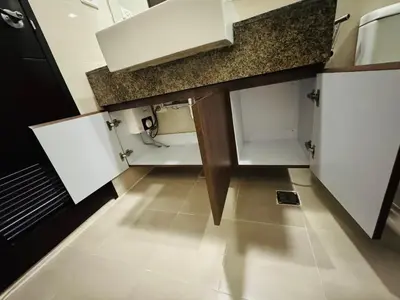 a small kitchen with white cabinets and a tile floor at Functional and Convenient stay in Eastwood City in Manila