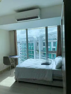 a bedroom with a bed and a large window at staycation at azure - near airport in Manila