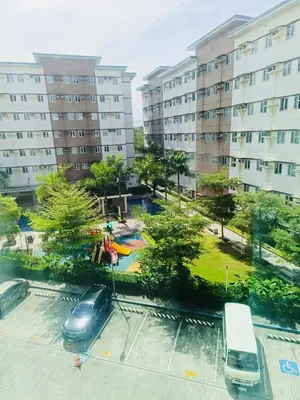a view of a parking lot with cars and a park at Casa Verde Suite - Staycation