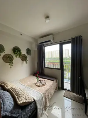a bedroom with a bed and a large window at Heartline Homes Shore 2 Residences in Manila