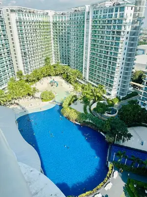 an aerial view of a resort with a pool and buildings at Deluxe penthouse unit at azure - near airport in Manila