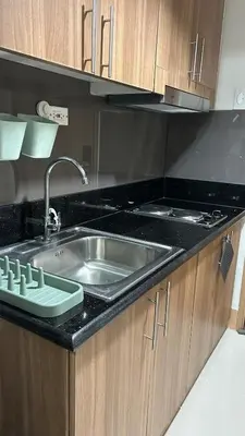 a kitchen with a sink and a counter top at Condotel 1BR w balcony at MOA SMDC Shore3 T1 in Manila