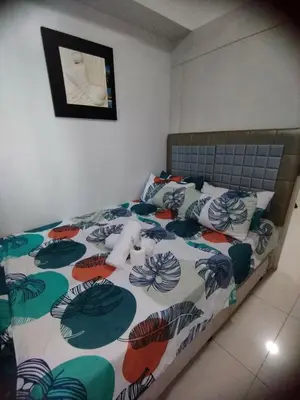 a bedroom with a bed with a colorful comforter at Sea Residences Staycation by Gladys in Manila