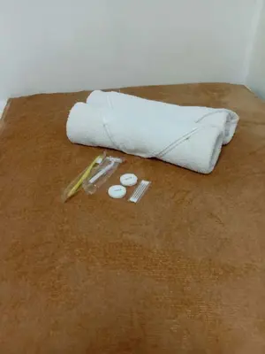 a towel and other items sitting on a floor at Condotel Sea Residence's Place Near Moa in Manila