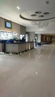 a lobby with a reception desk in a building at Condotel Sea Residence's Place Near Moa in Manila