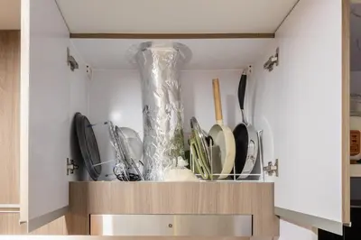 a vase sitting on top of a shelf in a kitchen at Cozy Modern Organic 1BR with Washer and WiFi Near BGC in Manila