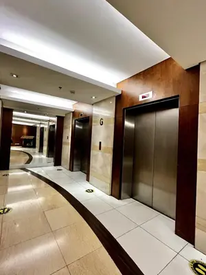 a lobby with two elevators in a building at Luxurious Homey Suite IN FRONT of US Embassy Manila Bay in Manila