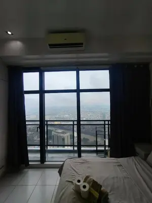 a bedroom with a bed and a large window at 1 BR Loft type in Manila