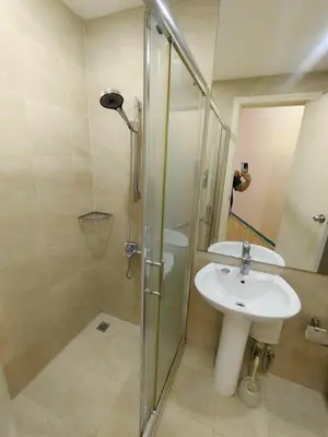 a bathroom with a sink and a shower at 1 BR Loft type in Manila